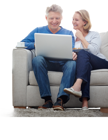 older couple on couch looking at computer